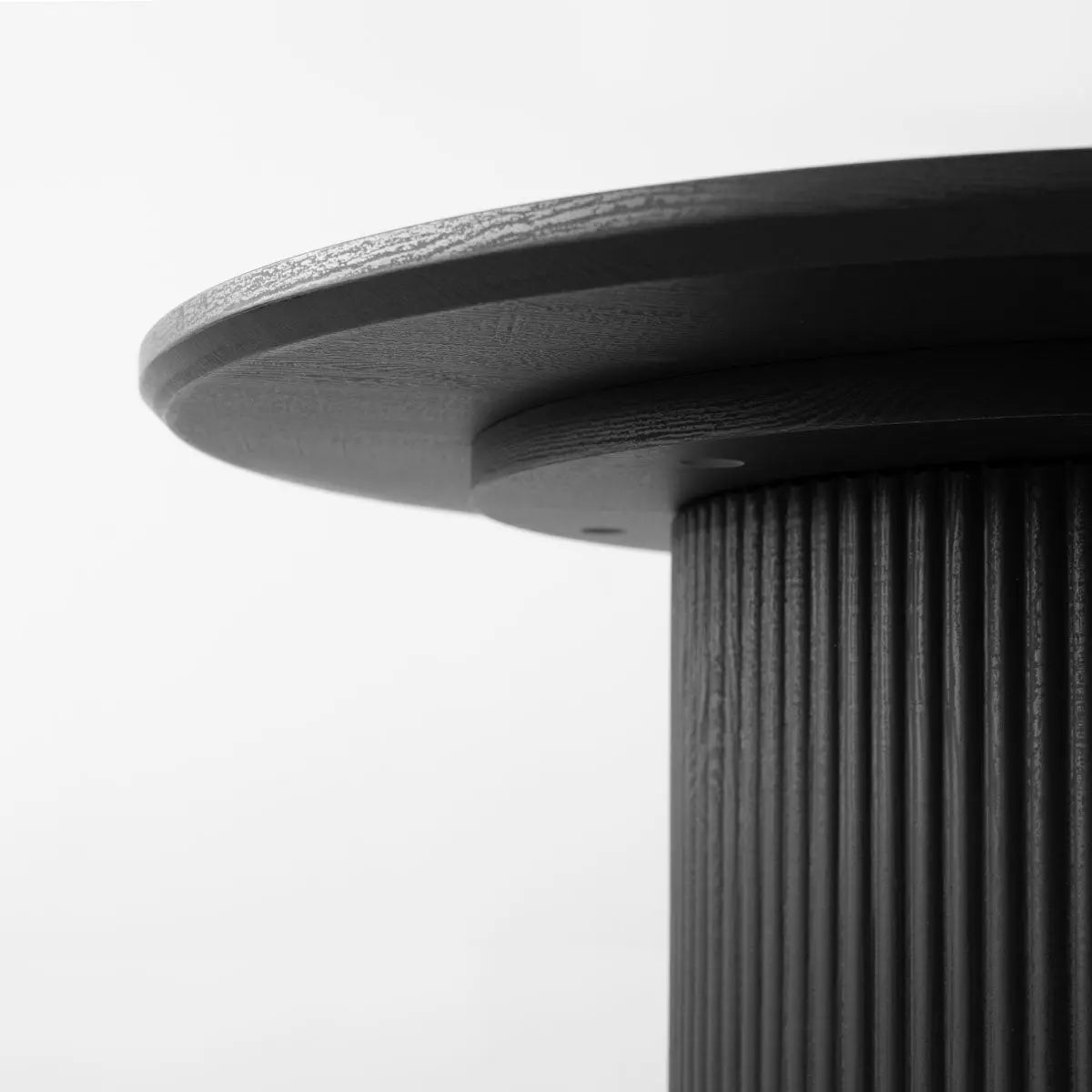 Close-up of Dwen Roman Pillar Oval Dining Table with textured pillar design, modern style.