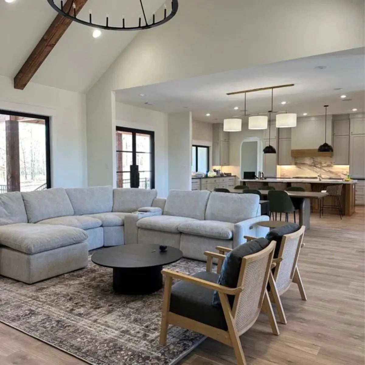 Dwen Modern Round Pedestal Coffee Table in cozy living room with gray sectional and wood flooring.