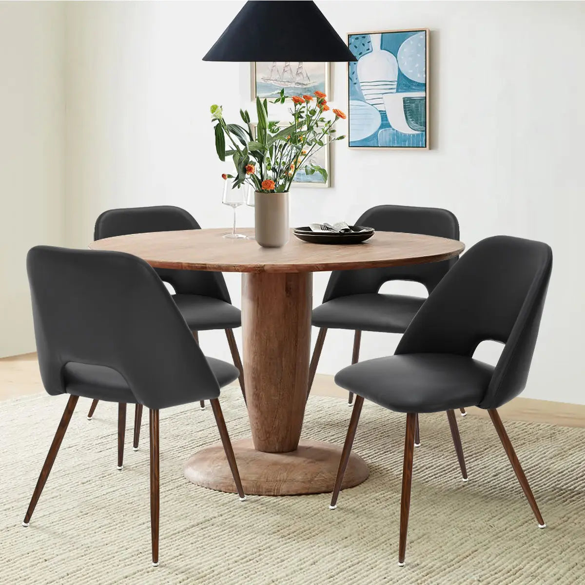 Edwin Modern Leather Dining Chair set around wooden table, wall art, beige rug in dining room.