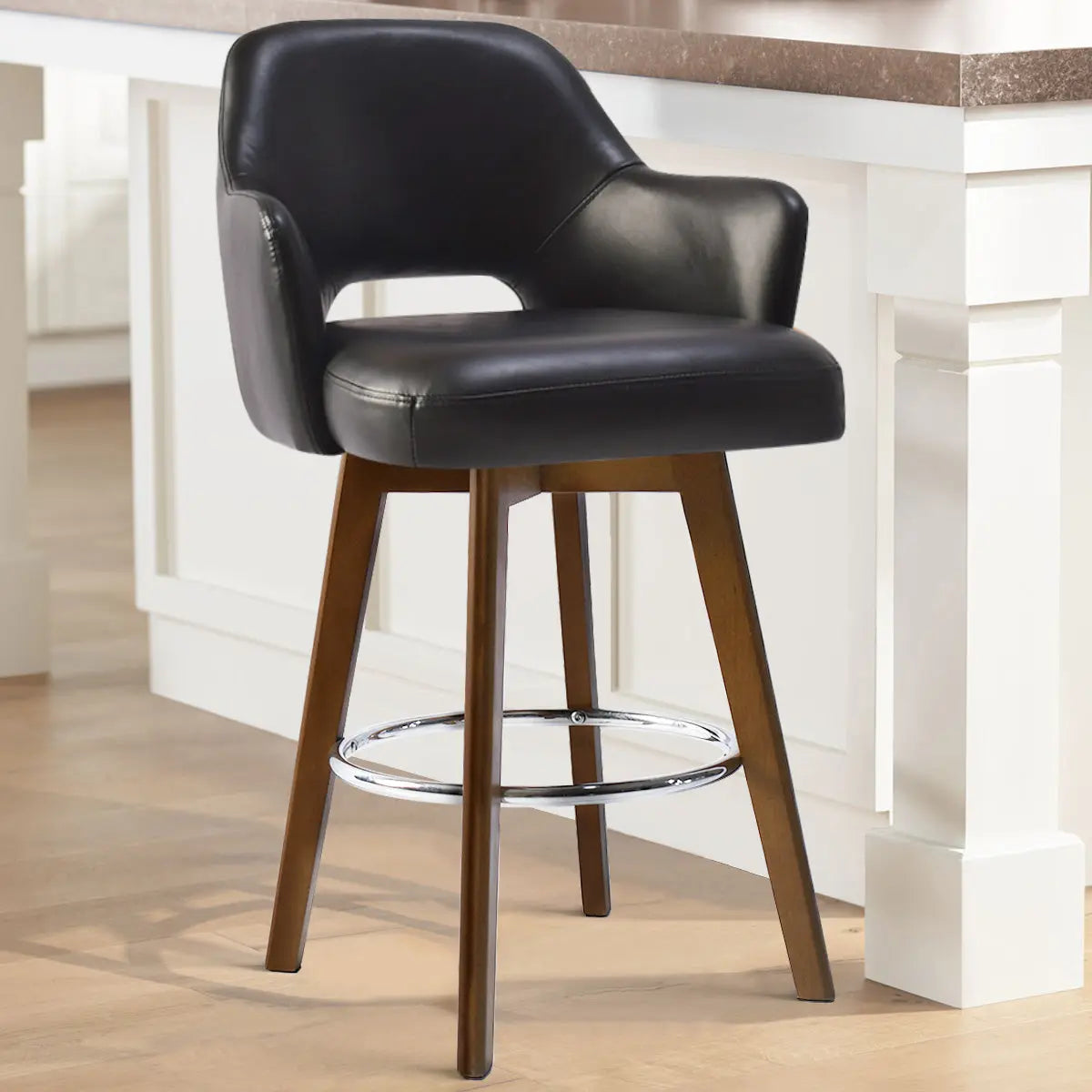 Edward 26" Faux Leather Swivel Counter Stool with arms, black finish, wooden legs, kitchen setting.