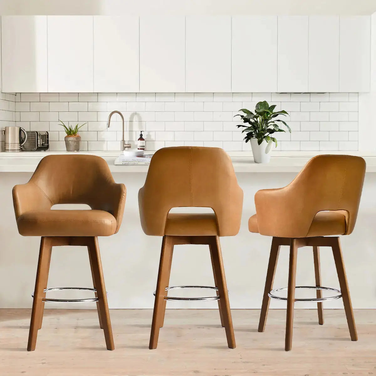 Edward Leather Swivel Counter Stool with Arms in modern kitchen, white cabinets, wood flooring.