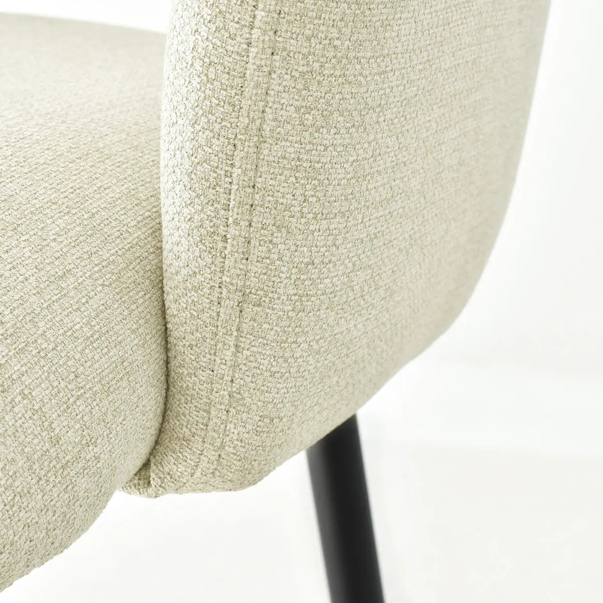 Close-up of Edwin Modern Upholstered Counter Stool with arms, beige fabric, black leg detail.