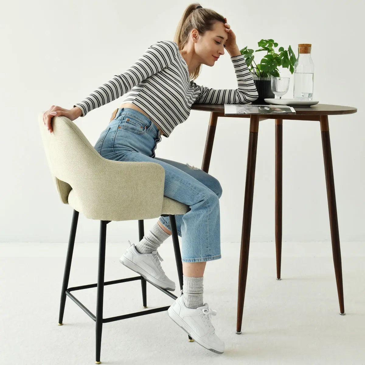 Edwin Modern Upholstered Counter Stool with Arms in neutral room, mid-century table, minimalist decor.