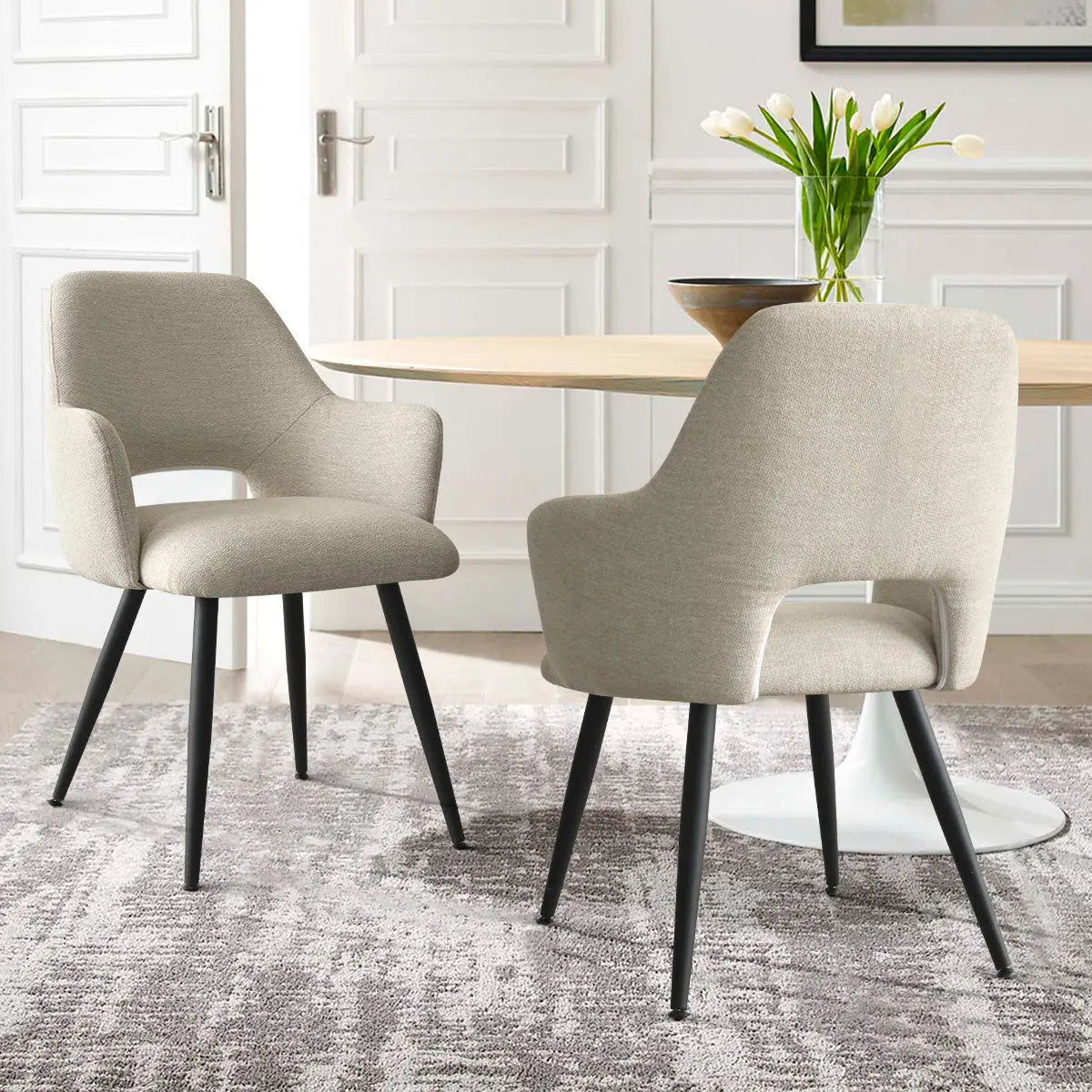 Edwin Modern Upholstered Dining Chair with arms in elegant dining room, light walls, grey rug.