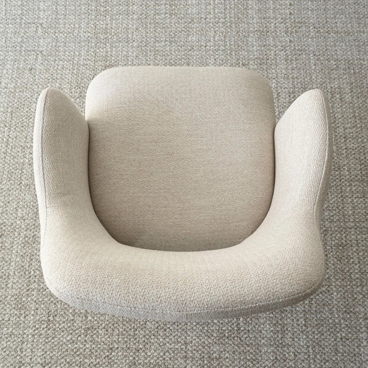 Top view of Edwin Modern Upholstered Dining Chair with Arms on textured carpet flooring.