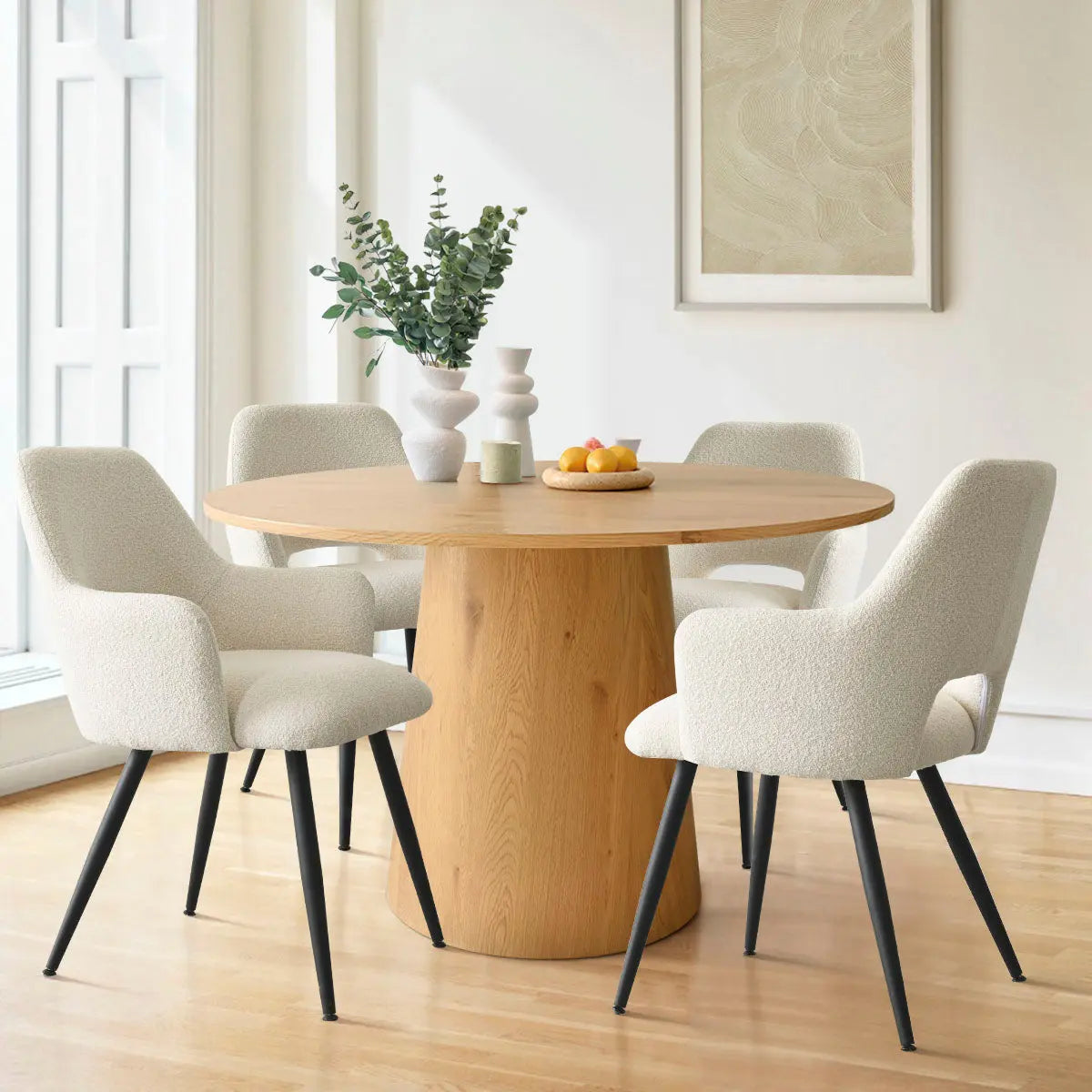 Edwin Modern Upholstered Dining Chair with Arms around wooden table in bright dining room, light flooring.