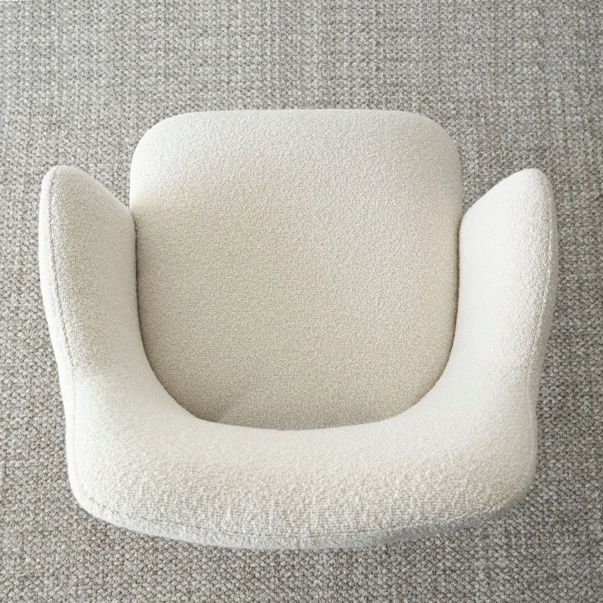 Top view of Edwin Modern Upholstered Dining Chair on textured carpet in neutral room setting.