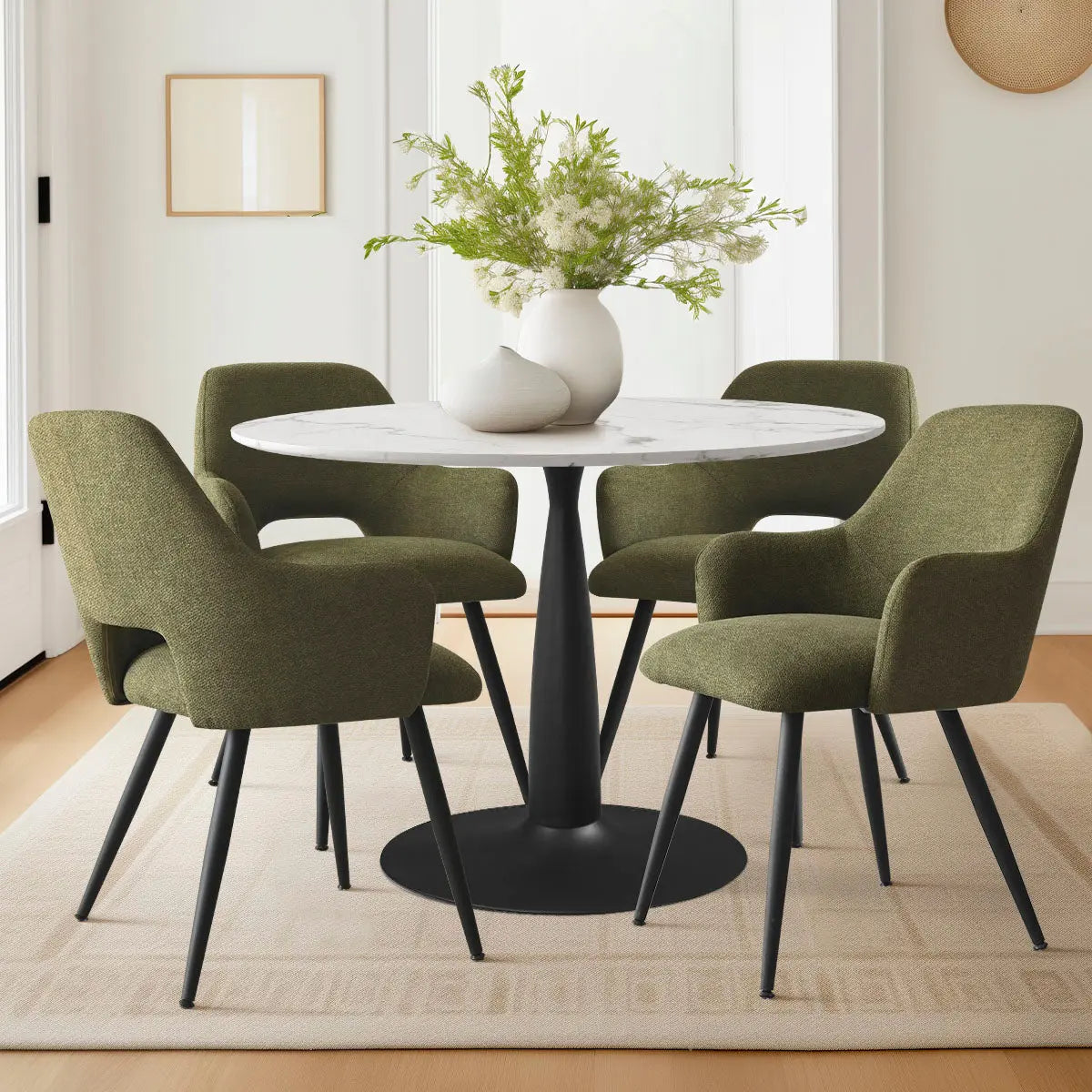 Edwin Modern Dining Chair with arms, green upholstery, round table, in stylish dining area, light walls.