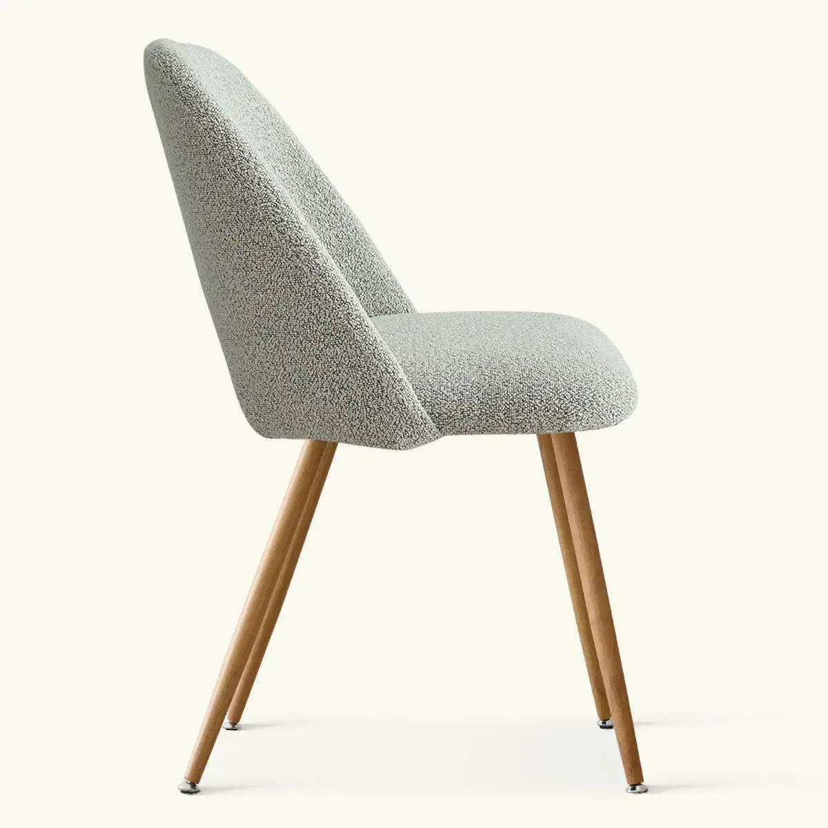 Edwin Boucle Upholstered Dining Chair side view with wooden legs, neutral room background.