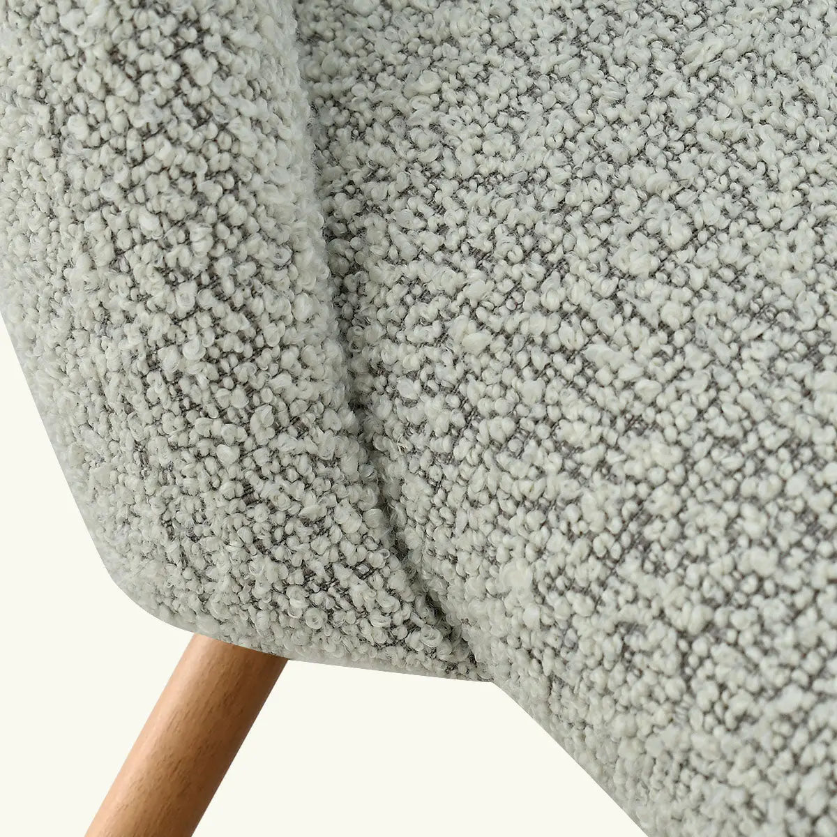 Close-up of textured fabric on Edwin Modern Upholstered Dining Chair, wooden leg detail visible.