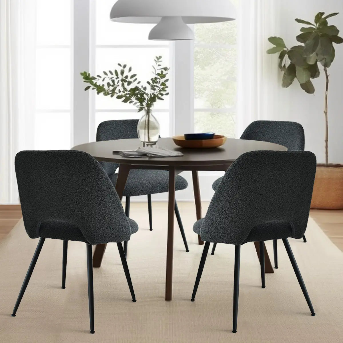 Edwin Modern Upholstered Dining Chair in dining room with wooden table, beige rug, and white pendant.