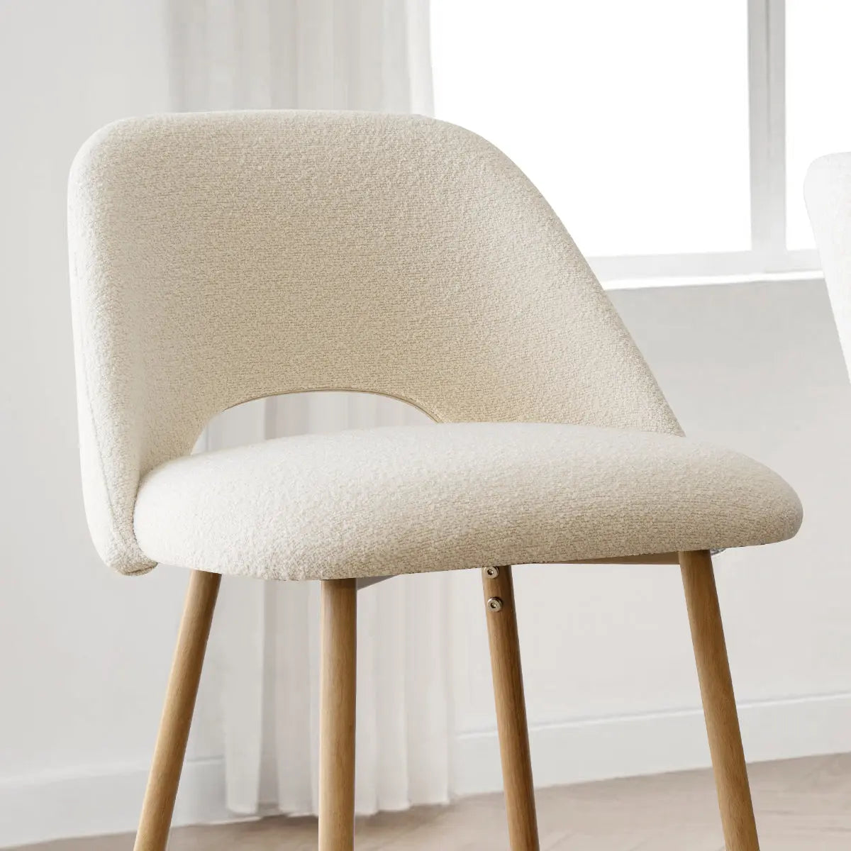 Edwin Modern Boucle stool with oak legs, white upholstery, and neutral room accents.