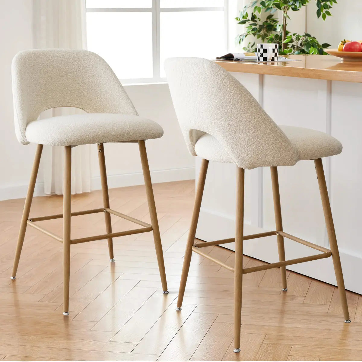 Edwin boucle counter stools with oak legs, modern kitchen setting, light wood flooring, natural light.