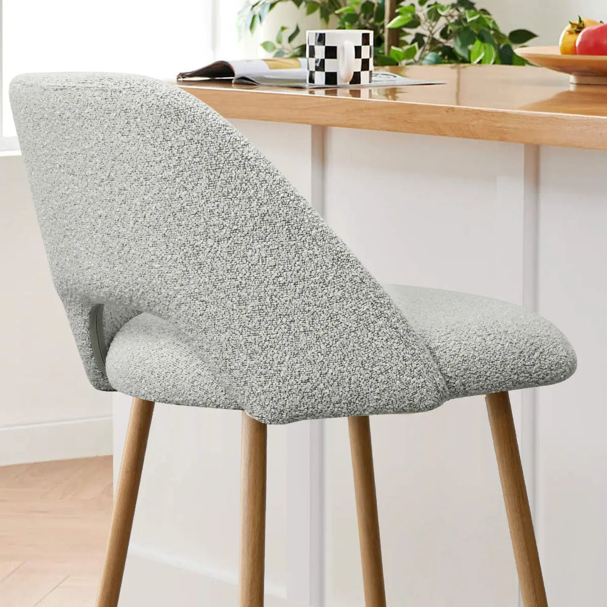 Edwin Modern Boucle Stool with oak legs in stylish kitchen, light wood flooring, white walls.