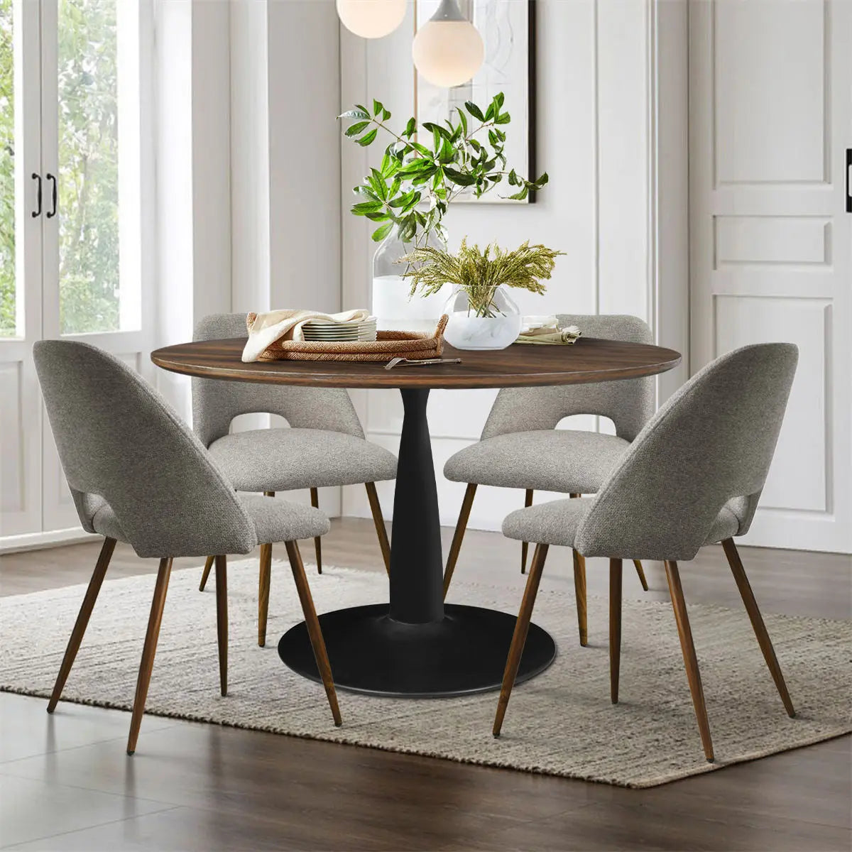 Harold & Edwin dining table set with gray chairs, wood flooring, white walls in modern dining room.