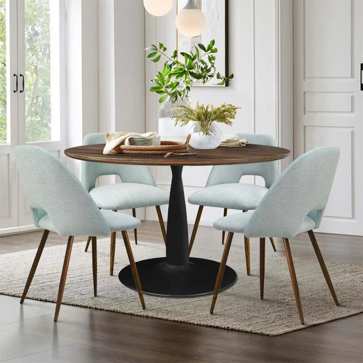 Harold & Edwin 40'' dining set in modern room with light wood flooring and white walls.