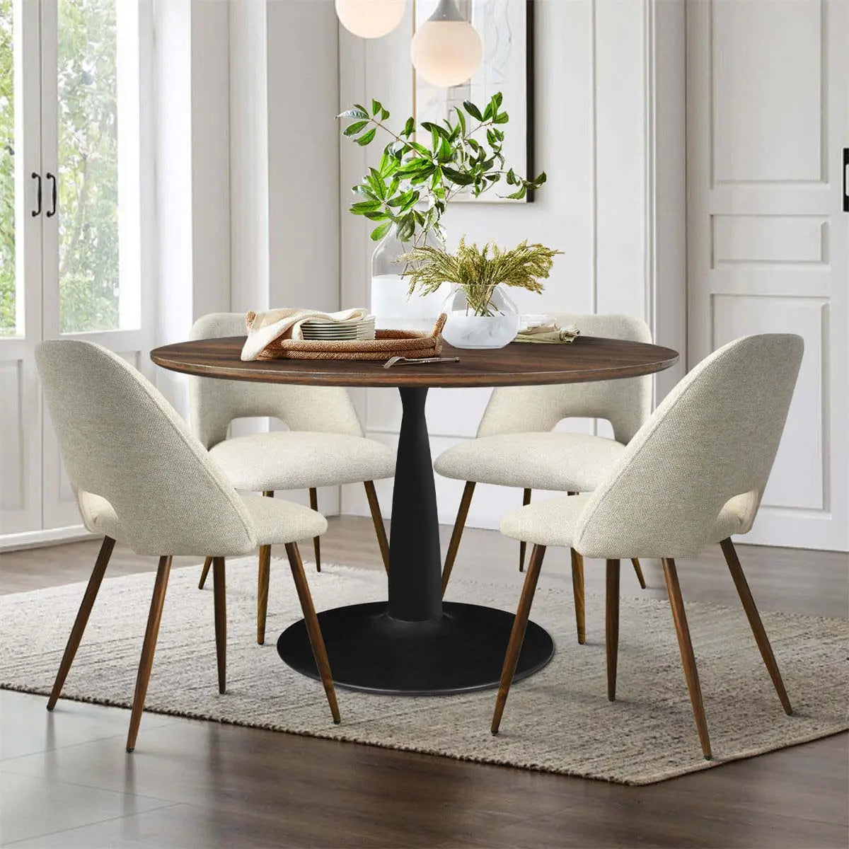 Harold & Edwin Round Dining Table Set with beige chairs, cozy dining room, light wood flooring.