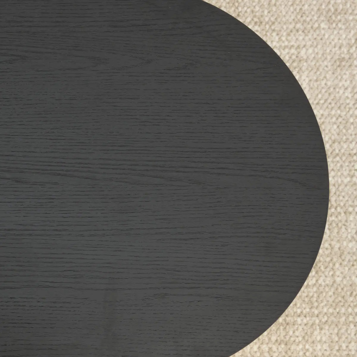 Hobo Modern Black Oval Coffee Table on beige textured carpet in living room setting.