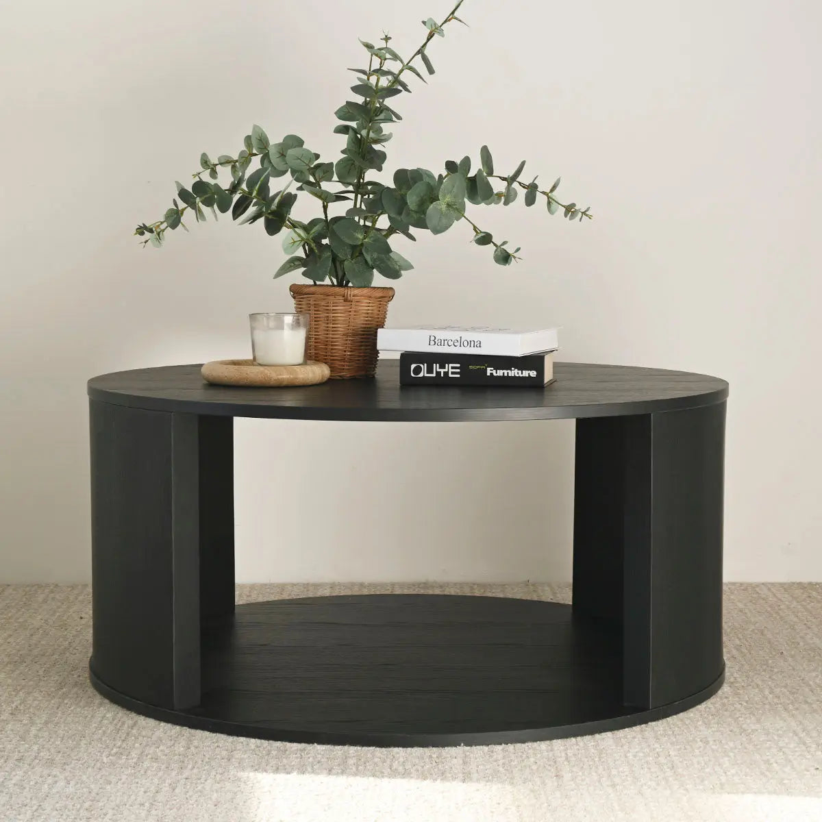 Hobo Modern Black Round Coffee Table in living room with beige carpet and light walls.