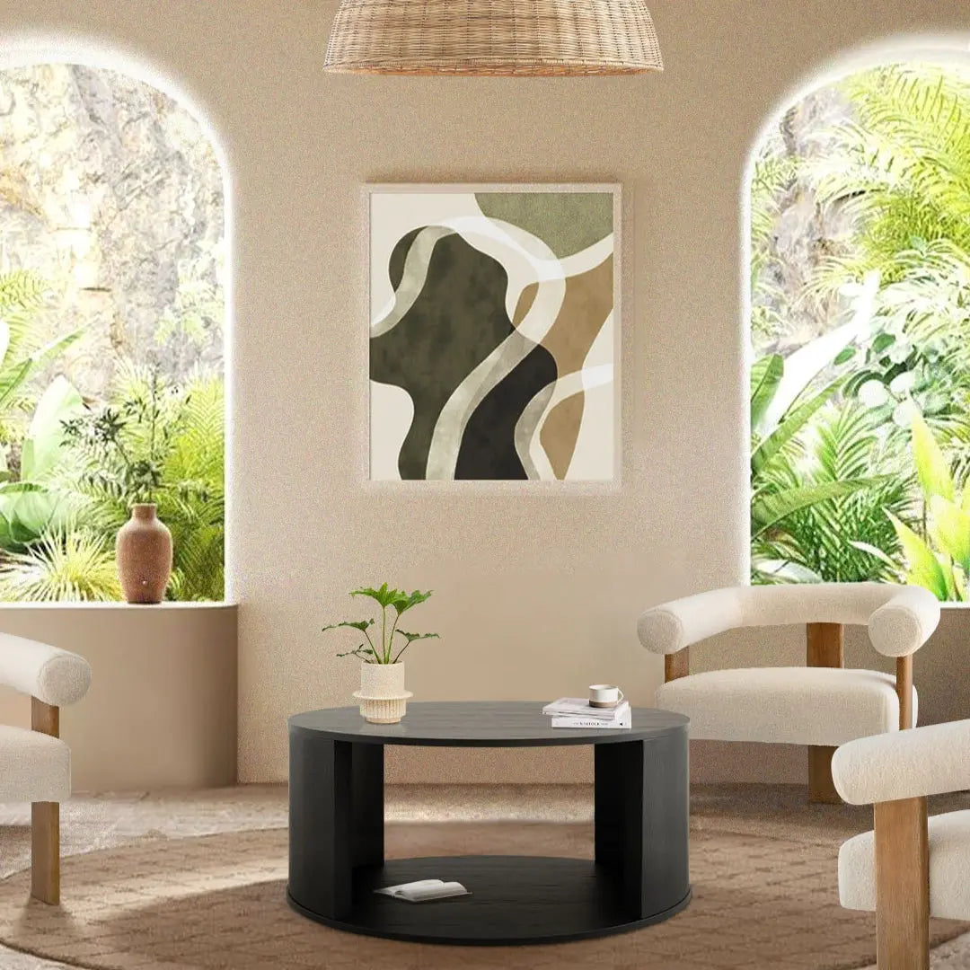 Hobo Modern Black Round Coffee Table in beige room with abstract wall art and cream chairs.