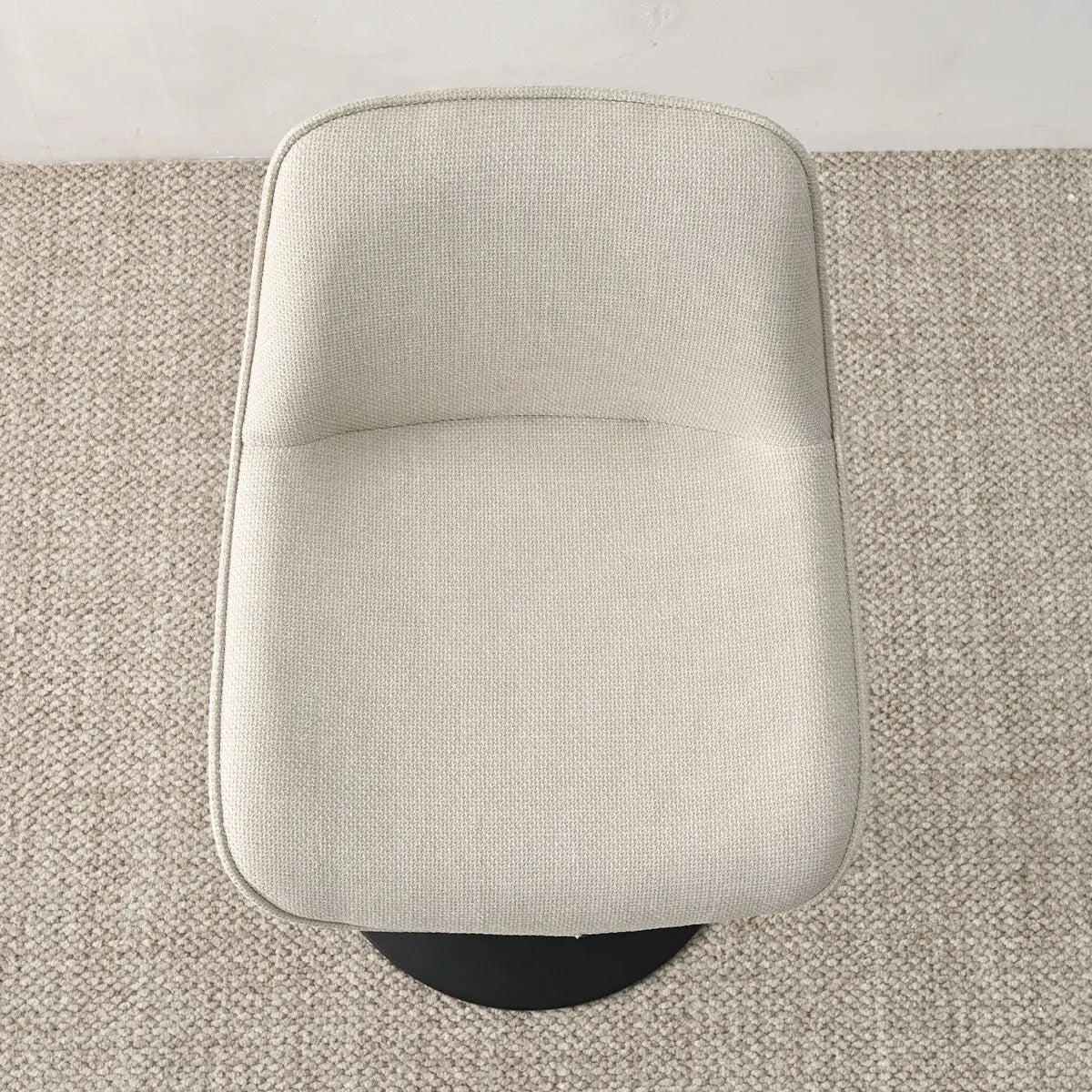 Hunter Modern beige upholstered swivel stool on textured carpet flooring.