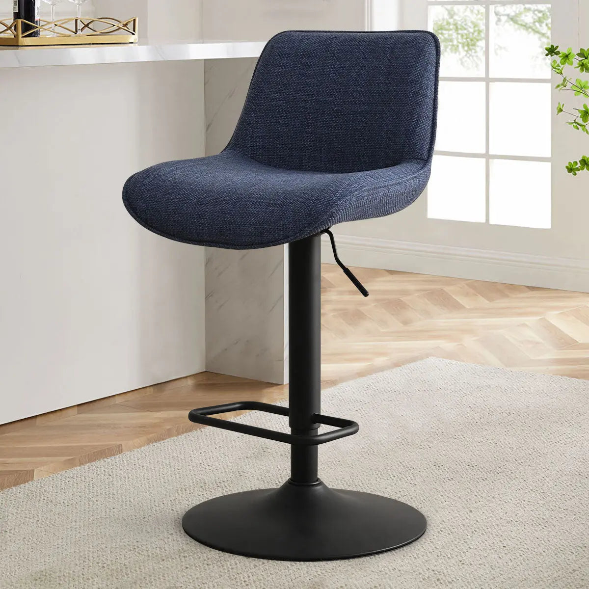 Hunter Modern Upholstered Swivel Adjustable Stool in blue, wood flooring, neutral rug, bright room.