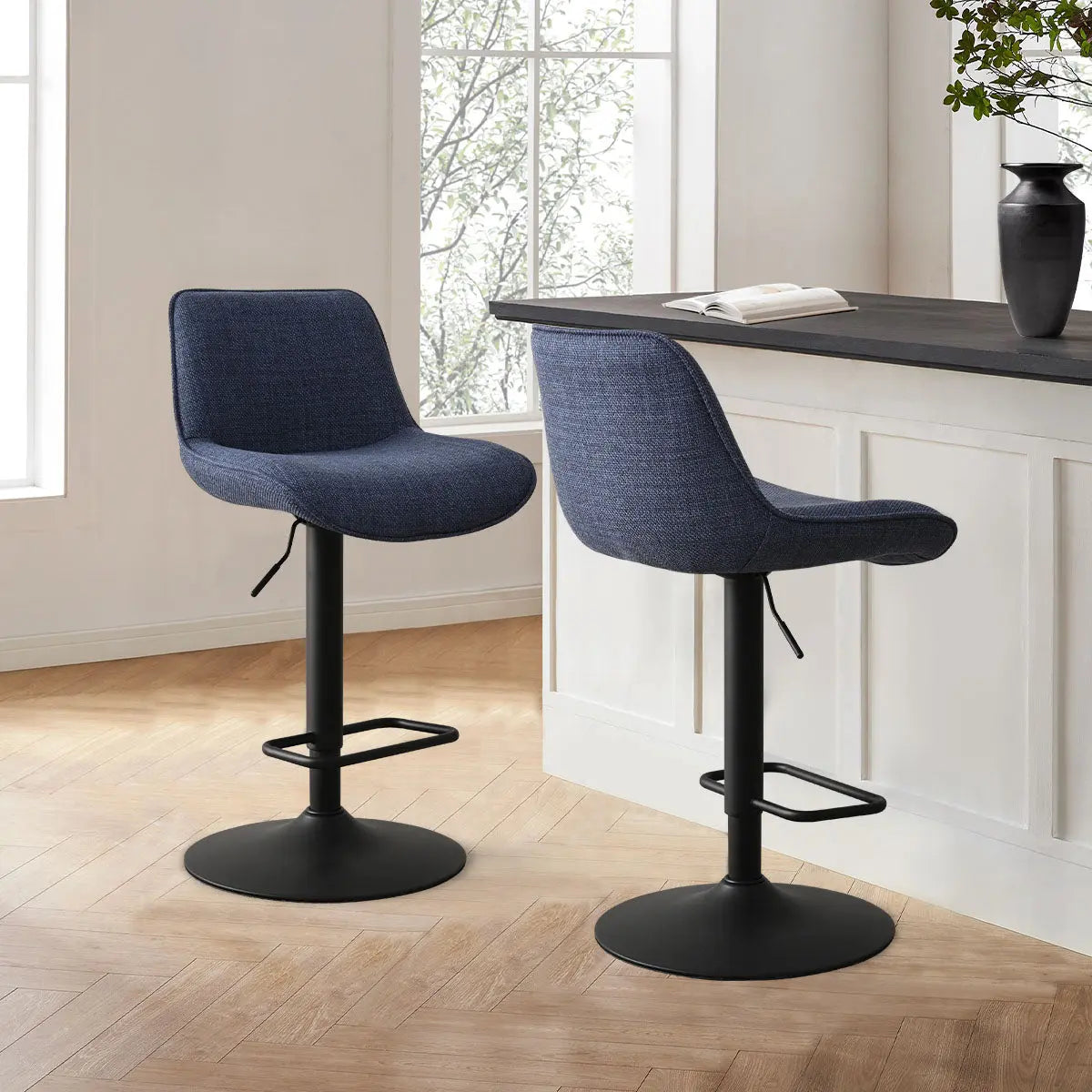 Hunter Modern Upholstered Swivel Adjustable Counter Stool in dining room, herringbone flooring, white walls.