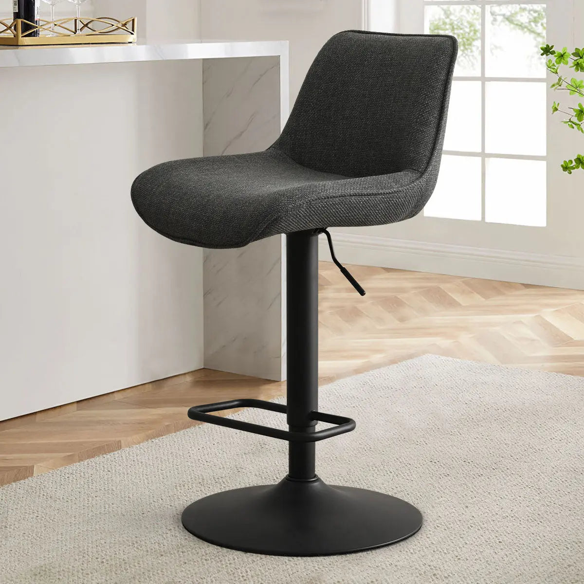 Hunter Modern Upholstered Swivel Adjustable Counter Stool in kitchen with herringbone flooring and neutral decor.