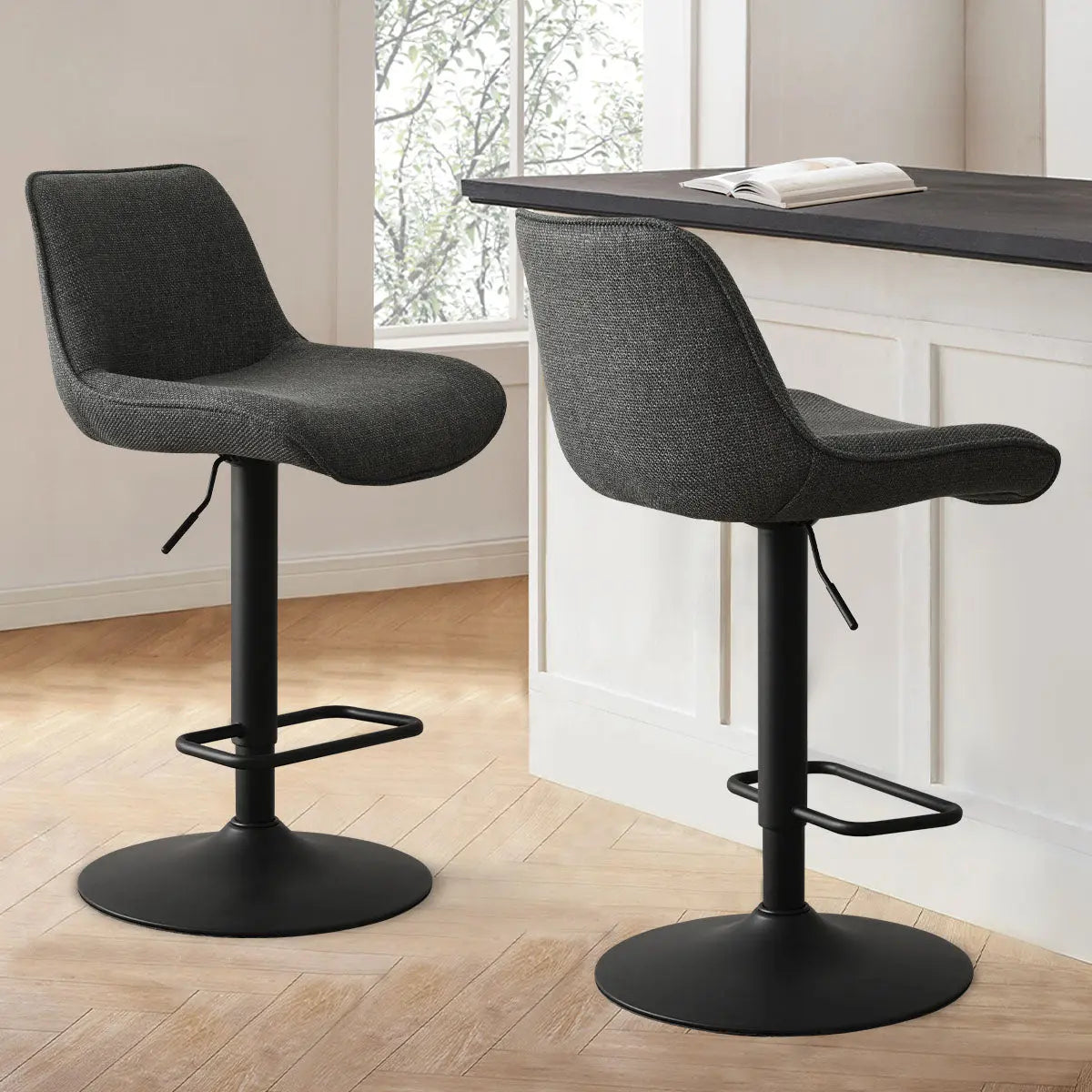 Two Hunter Modern Upholstered Swivel Adjustable Counter Stools in stylish kitchen with light wood flooring.