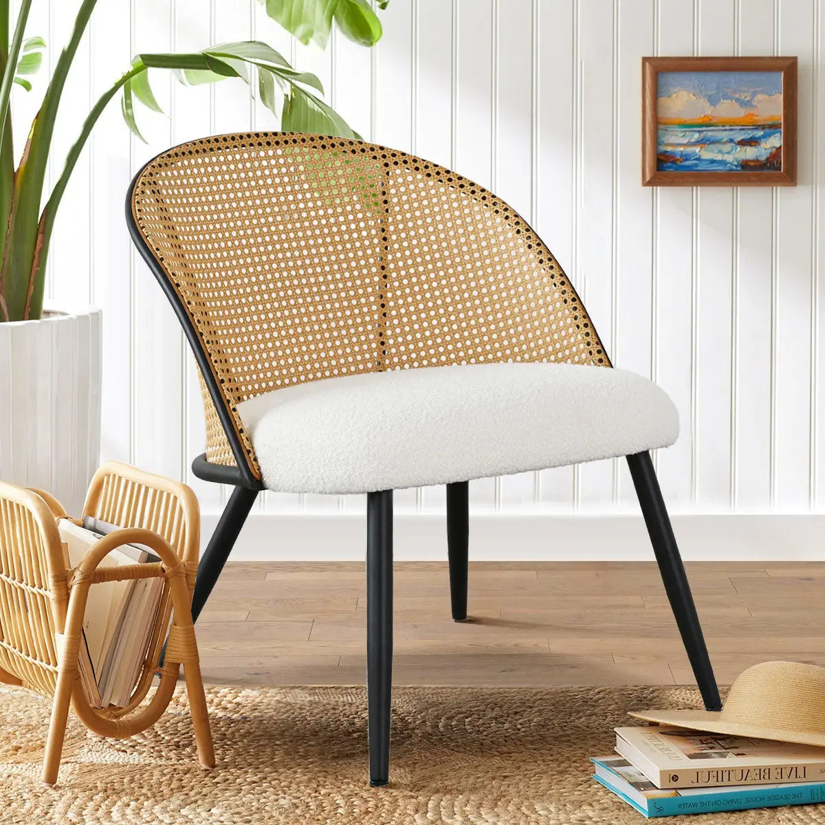 Jules Modern Upholstered Rattan Dining Chair in cozy room with wood flooring and white panel wall.