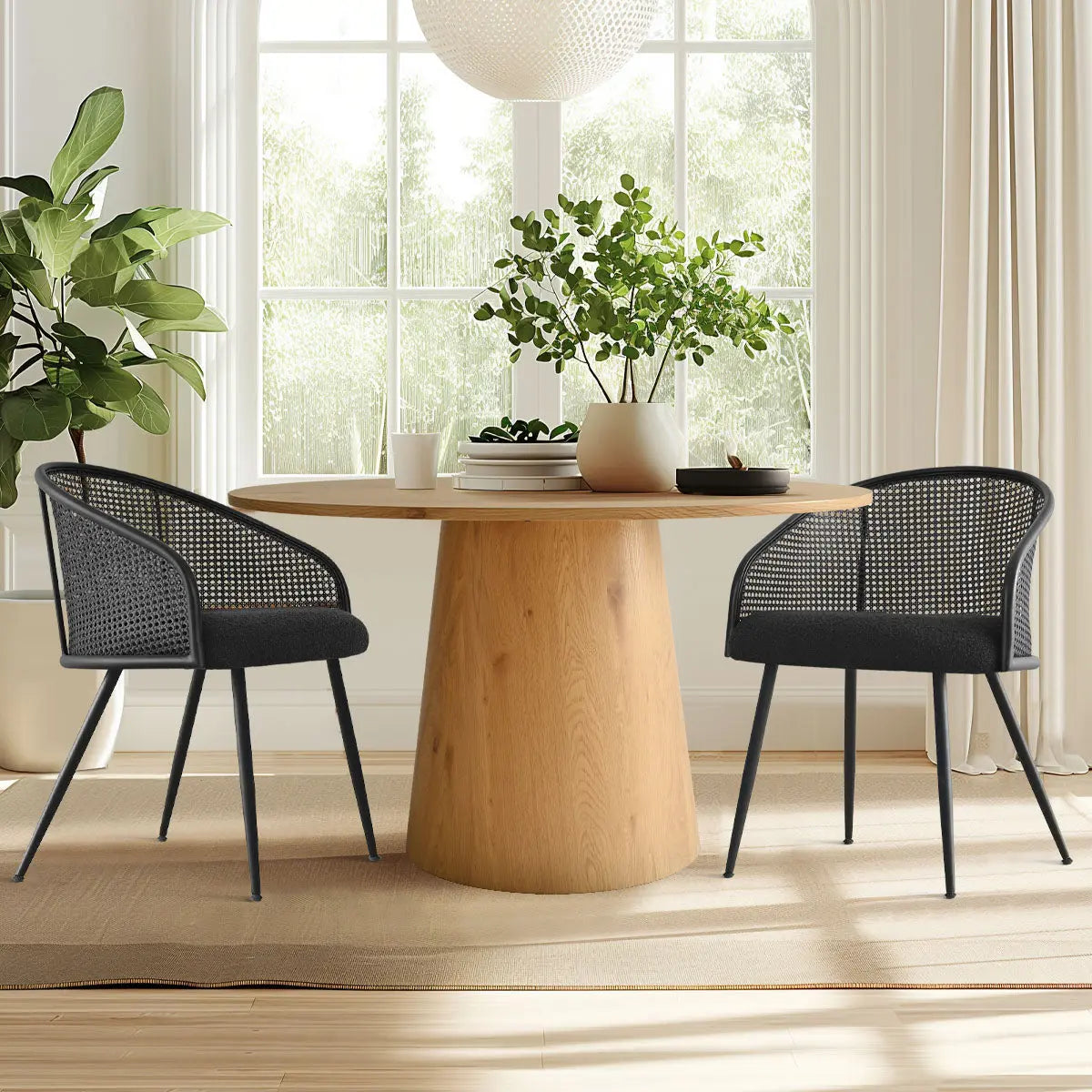 Jules Modern Rattan Dining Chair with Arms, wood dining table, neutral curtains, hardwood flooring, bright room.