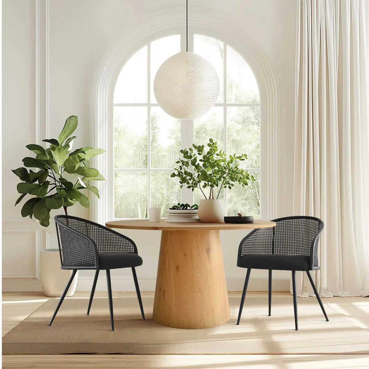 Jules Modern upholstered rattan dining chairs with arms around wooden table in bright dining room.