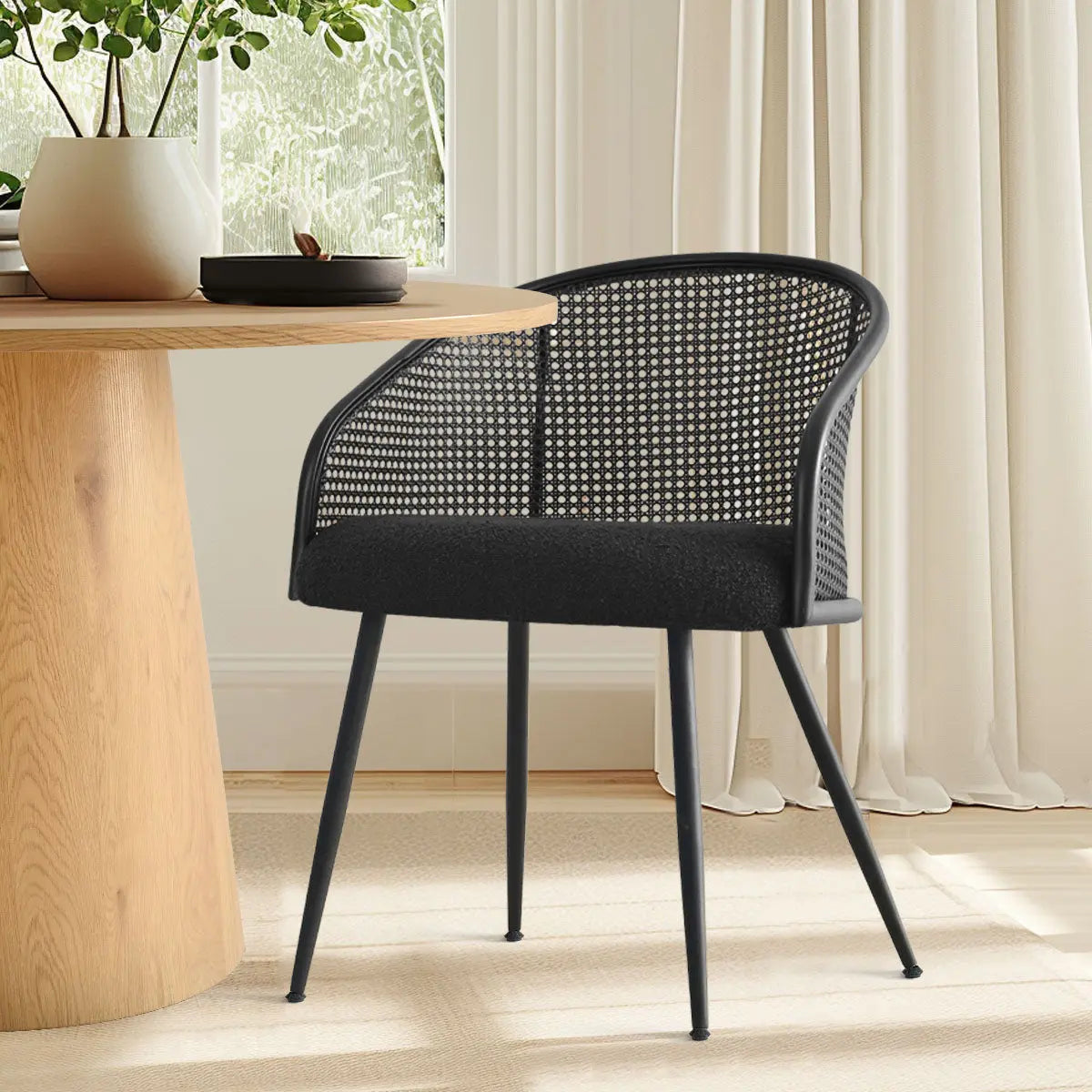 Jules Modern Rattan Dining Chair with Textile Upholstery, wooden table, light curtains, dining room.