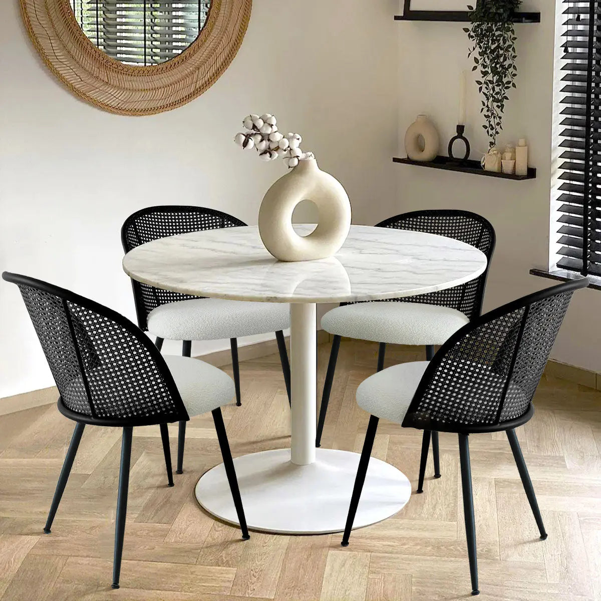 Jules Modern Upholstered Rattan Dining Chair set around marble table on herringbone wood flooring.