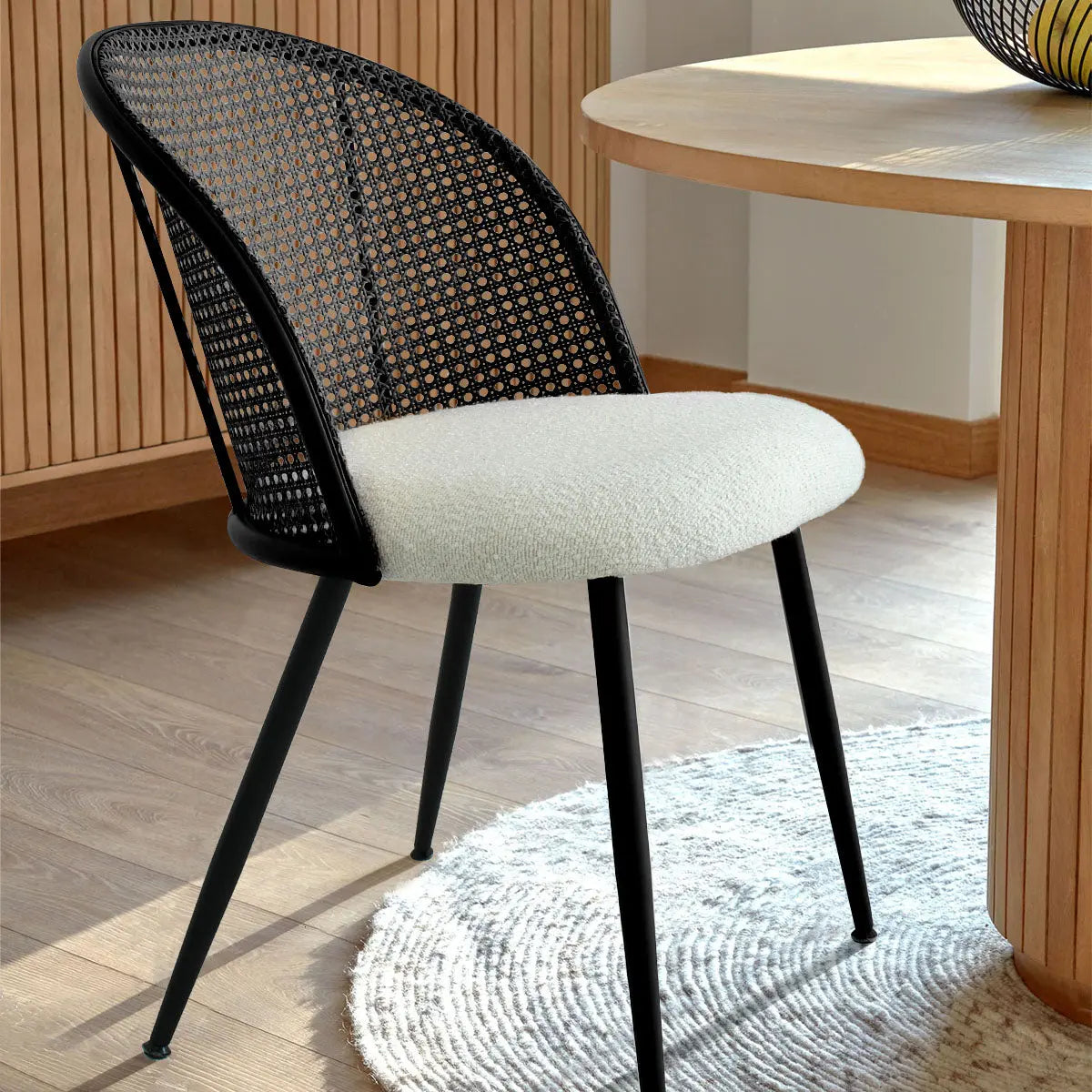 Jules Modern Upholstered Rattan Dining Chair, light wood flooring, round table, modern room decor.