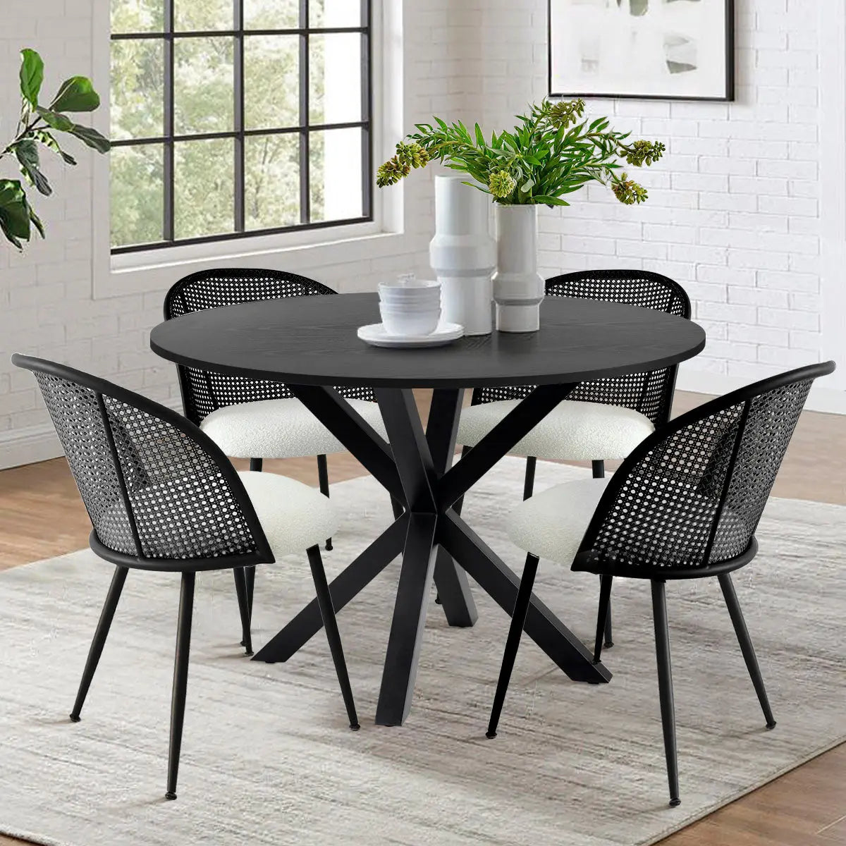 Jules Modern Upholstered Rattan Dining Chair set with black table, white brick wall, light rug.