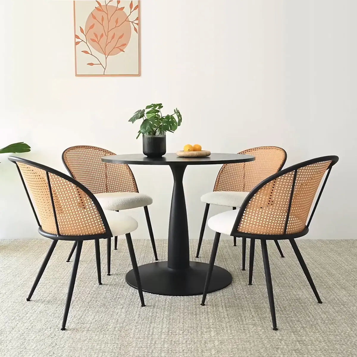 Jules Modern Upholstered Rattan Dining Chair, black round table, beige carpet, minimal wall art.