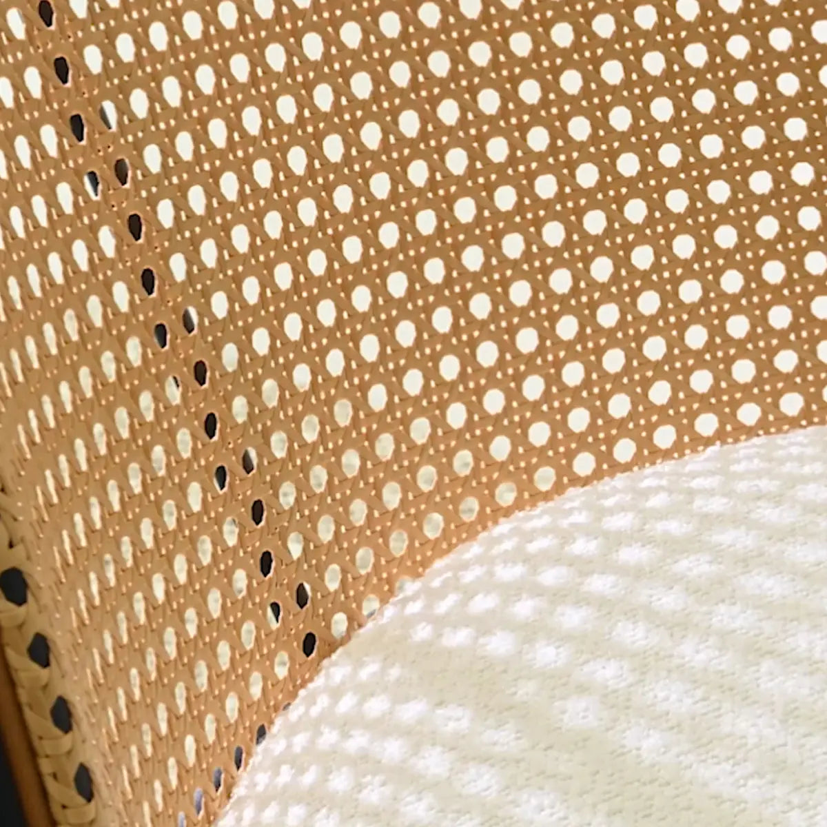 Close-up of upholstered rattan texture on Jules Modern Dining Chair, showcasing intricate pattern detail.