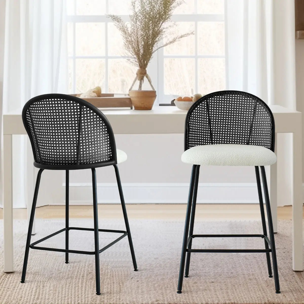 Pair of Jules Modern Upholstered Rattan Counter Stools in dining room with soft beige carpet flooring.