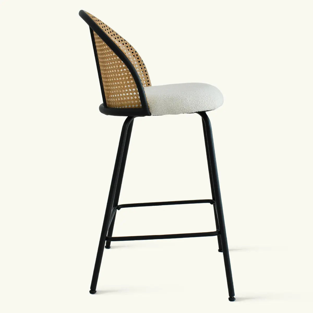 Jules Modern Upholstered Rattan Counter Stool, black metal legs, neutral cushion, rattan backrest design.