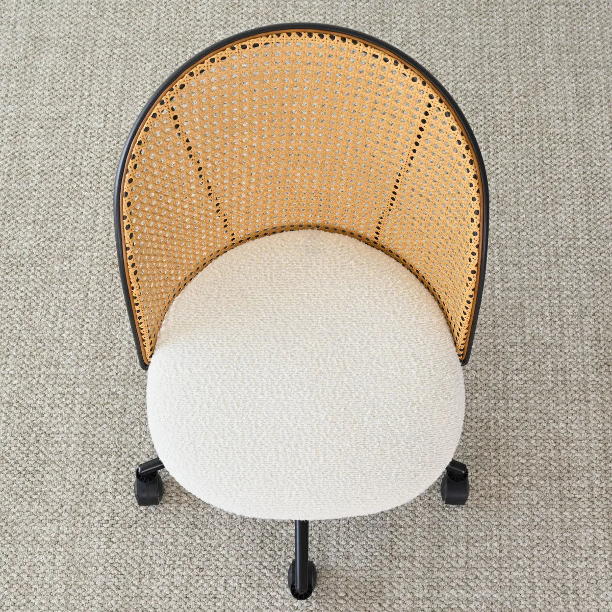 Top view of Jules Modern Upholstered Rattan Swivel Office Chair on beige carpet flooring.