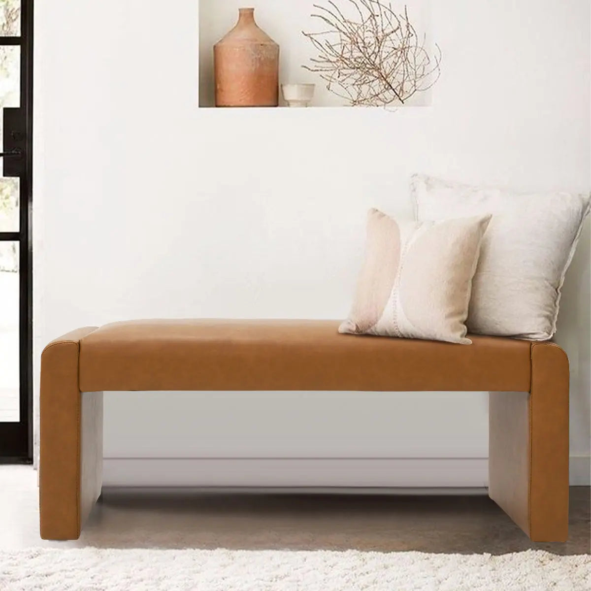 Kaia Modern Leather & Velvet Waterfall Bench in living room with neutral decor and plush carpet.