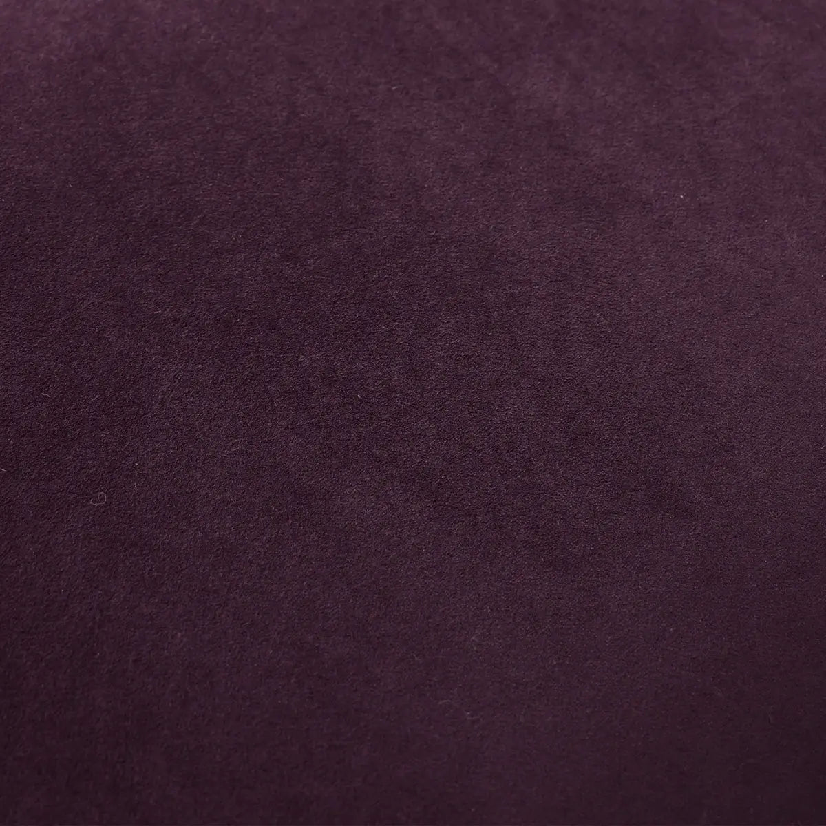 Close-up texture of Kaia leather and velvet, deep purple color detail.