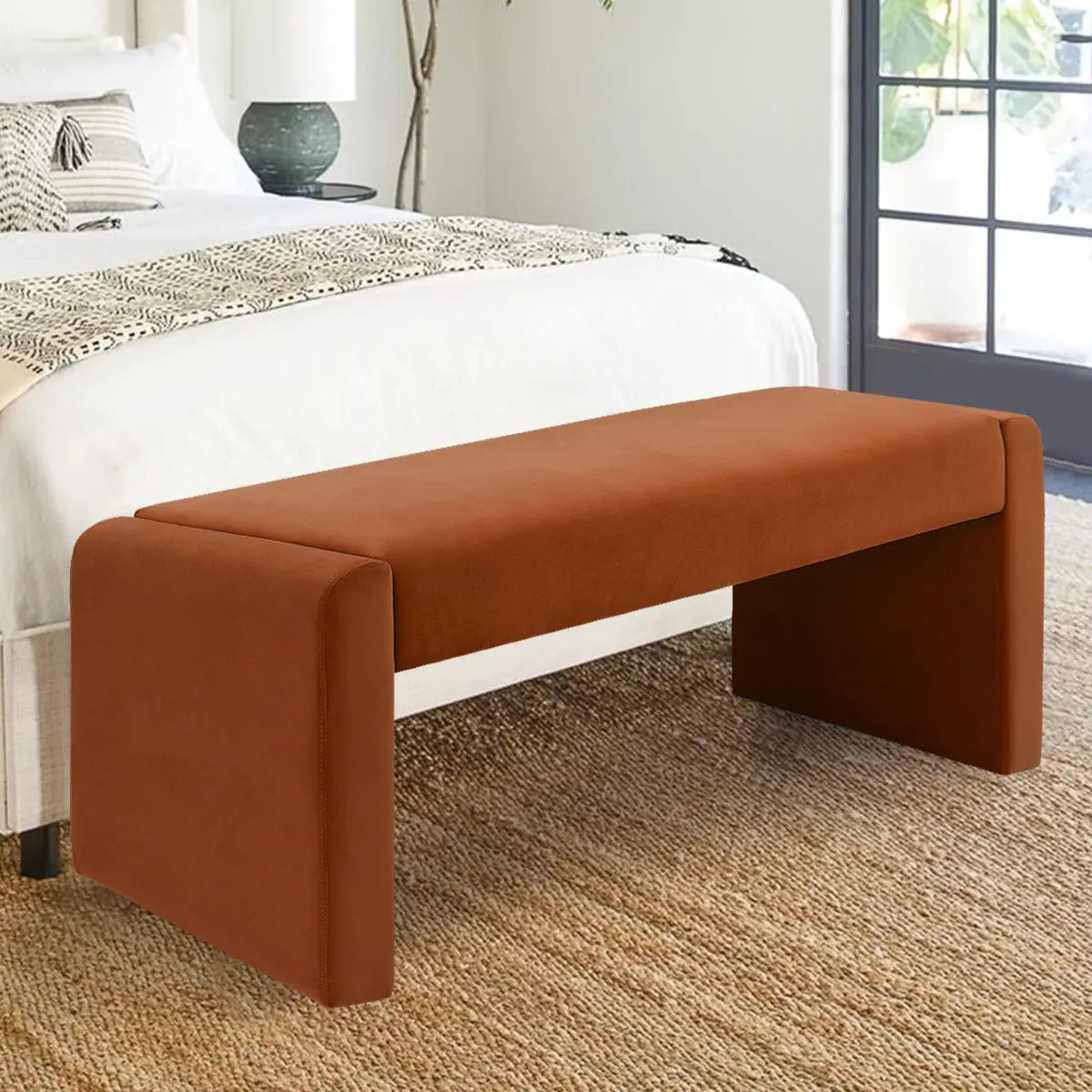 Kaia Modern Leather & Velvet Waterfall Bench in cozy bedroom with neutral walls and woven rug.