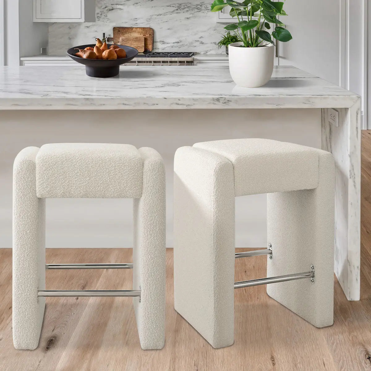 Kaia Modern Beige Boucle Counter Stool with marble island, wood flooring in contemporary kitchen setting.