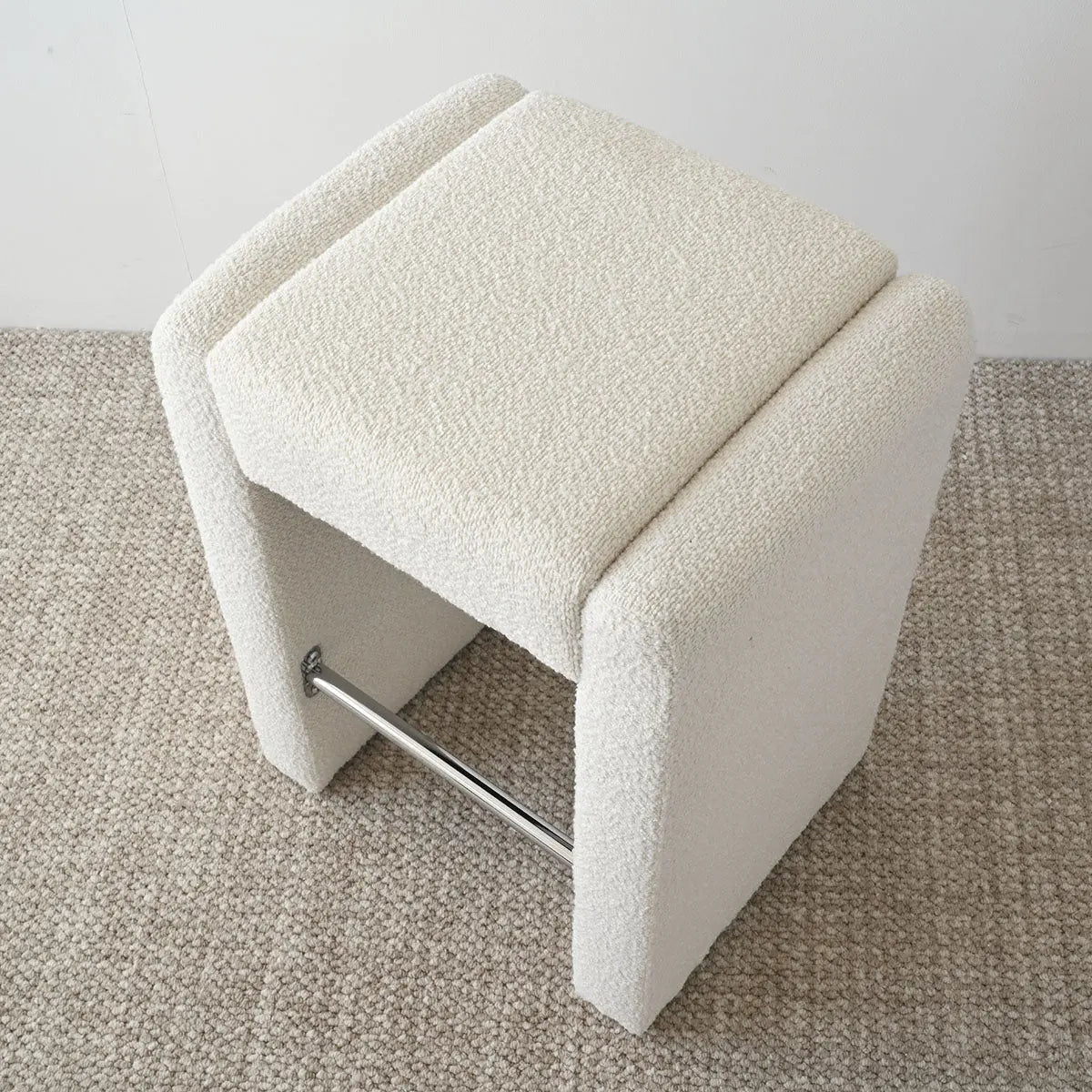 Kaia Modern Beige Boucle Counter Stool on textured carpet flooring, minimalist design.