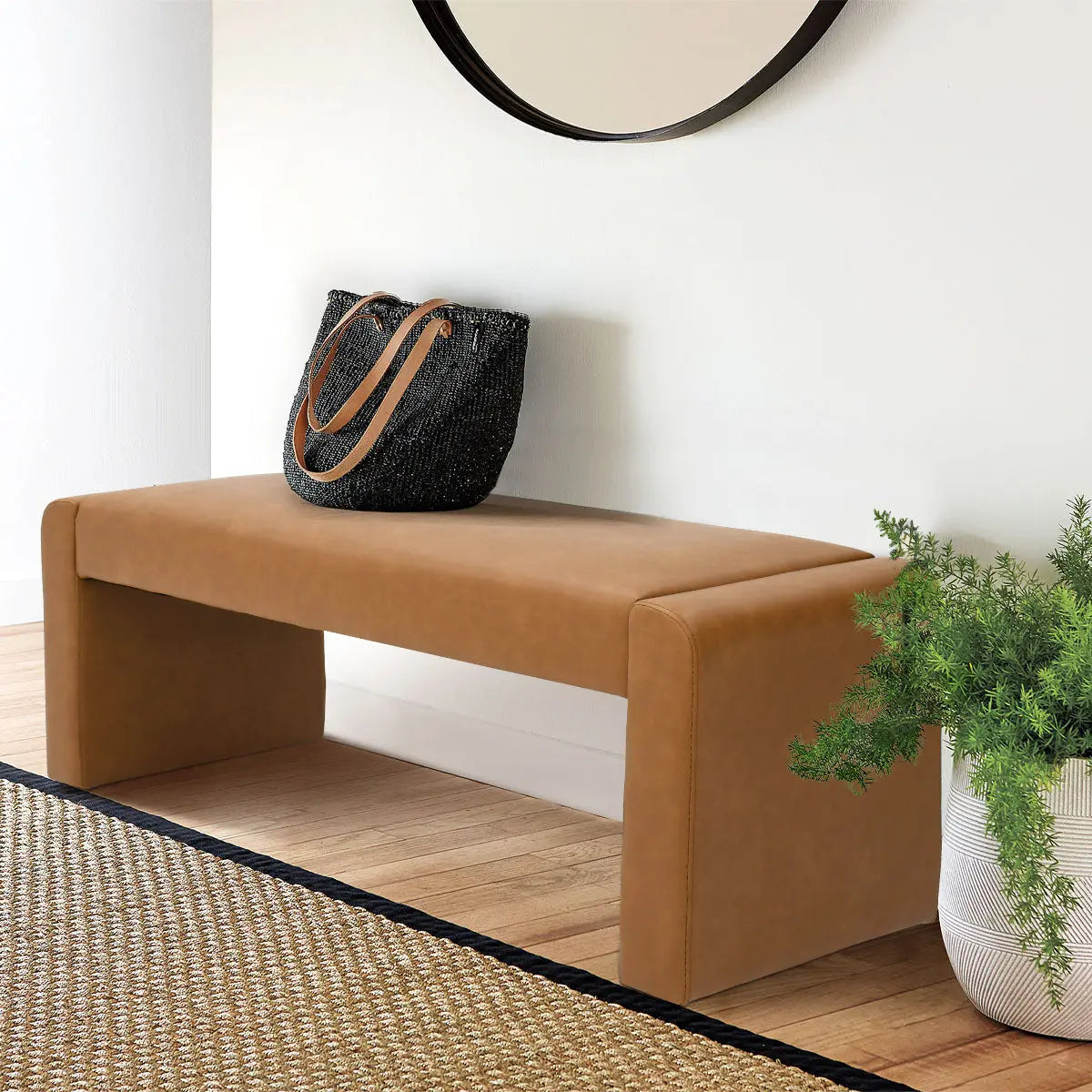 Kaia Modern Leather & Velvet Waterfall Bench in room, wooden floor, white wall, round mirror.