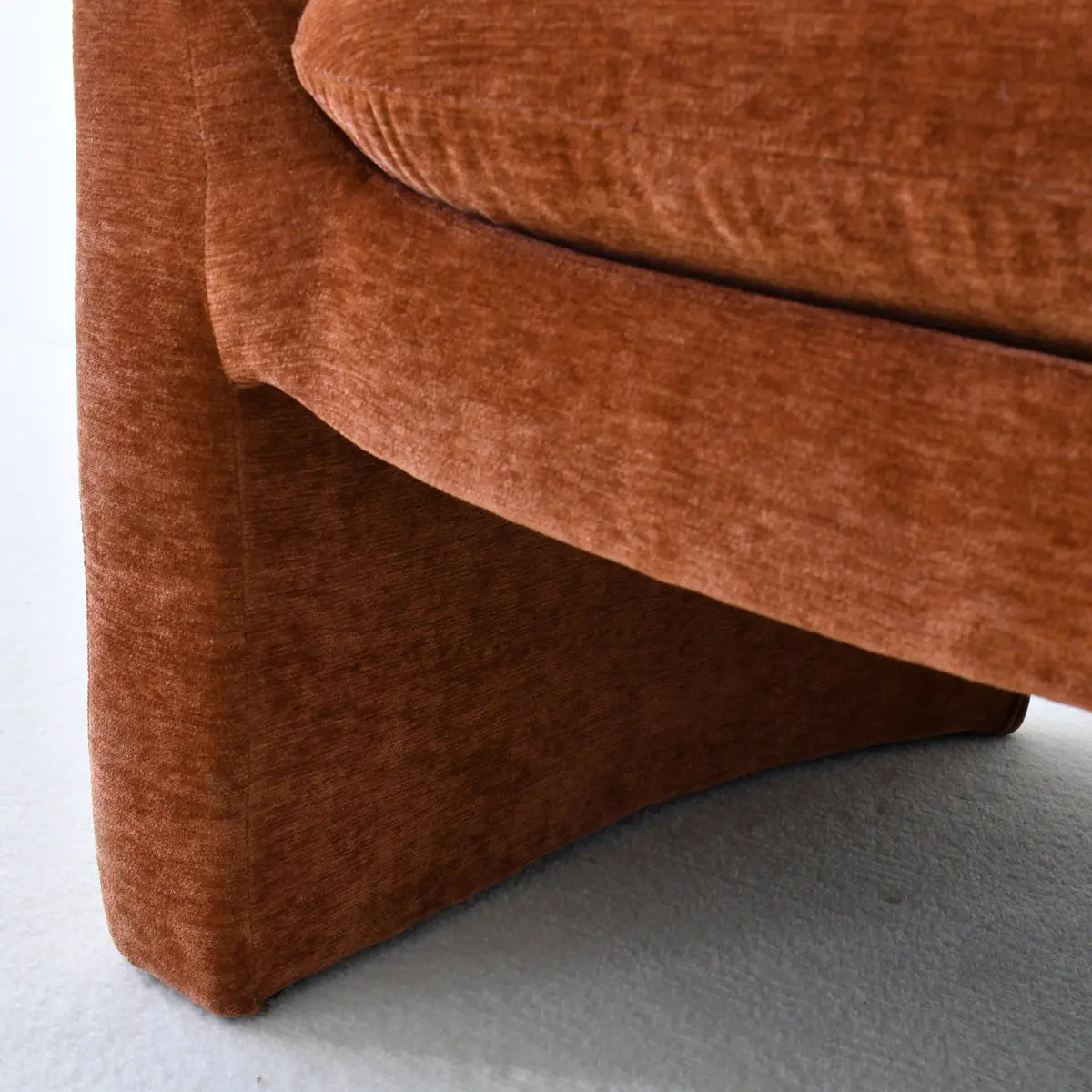 Close-up of Kiki Modern Chenille Boucle Accent Chair cushion, rust color fabric texture detail.