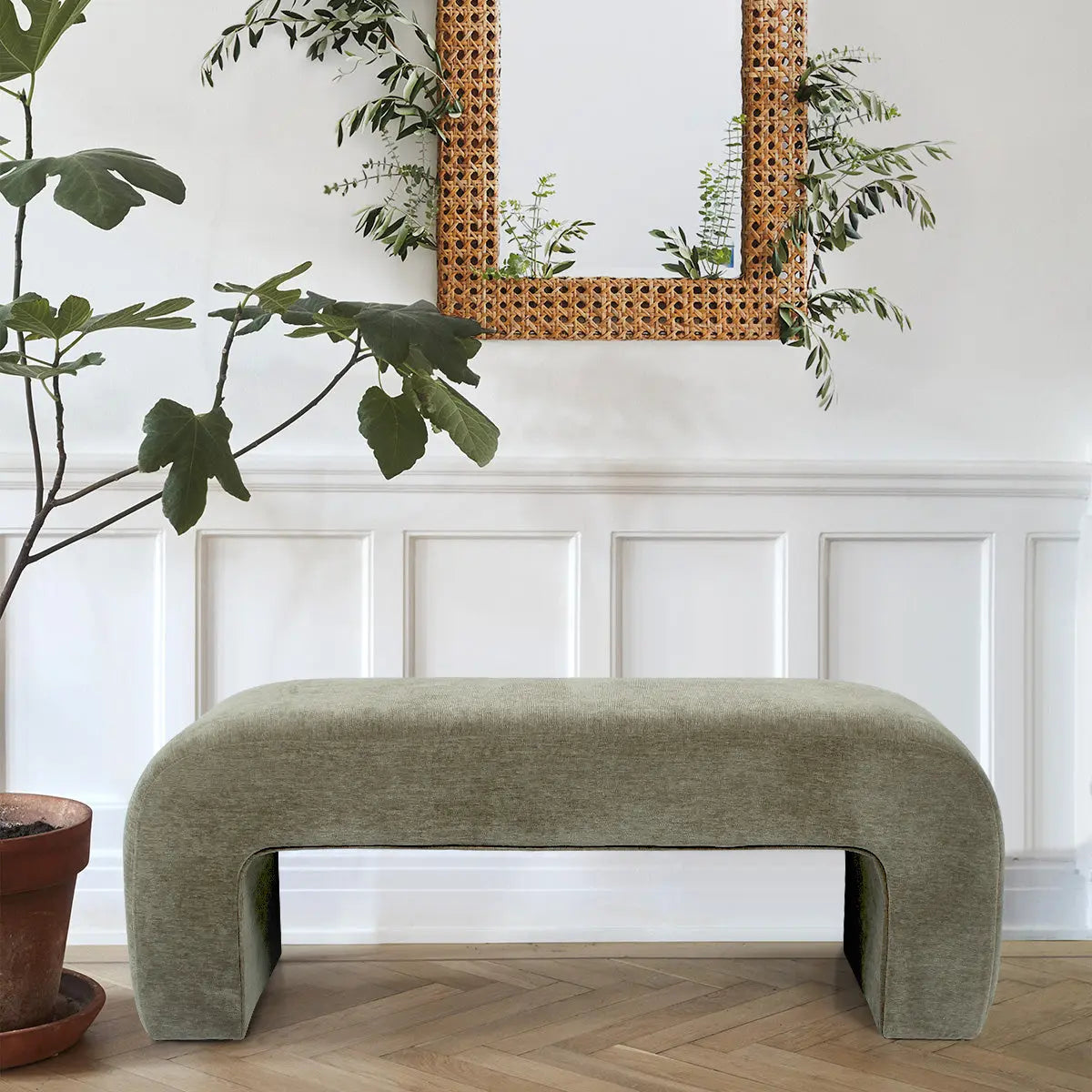 Green Lily Chenille Waterfall Bench in elegant room with herringbone flooring and decorative wall paneling.