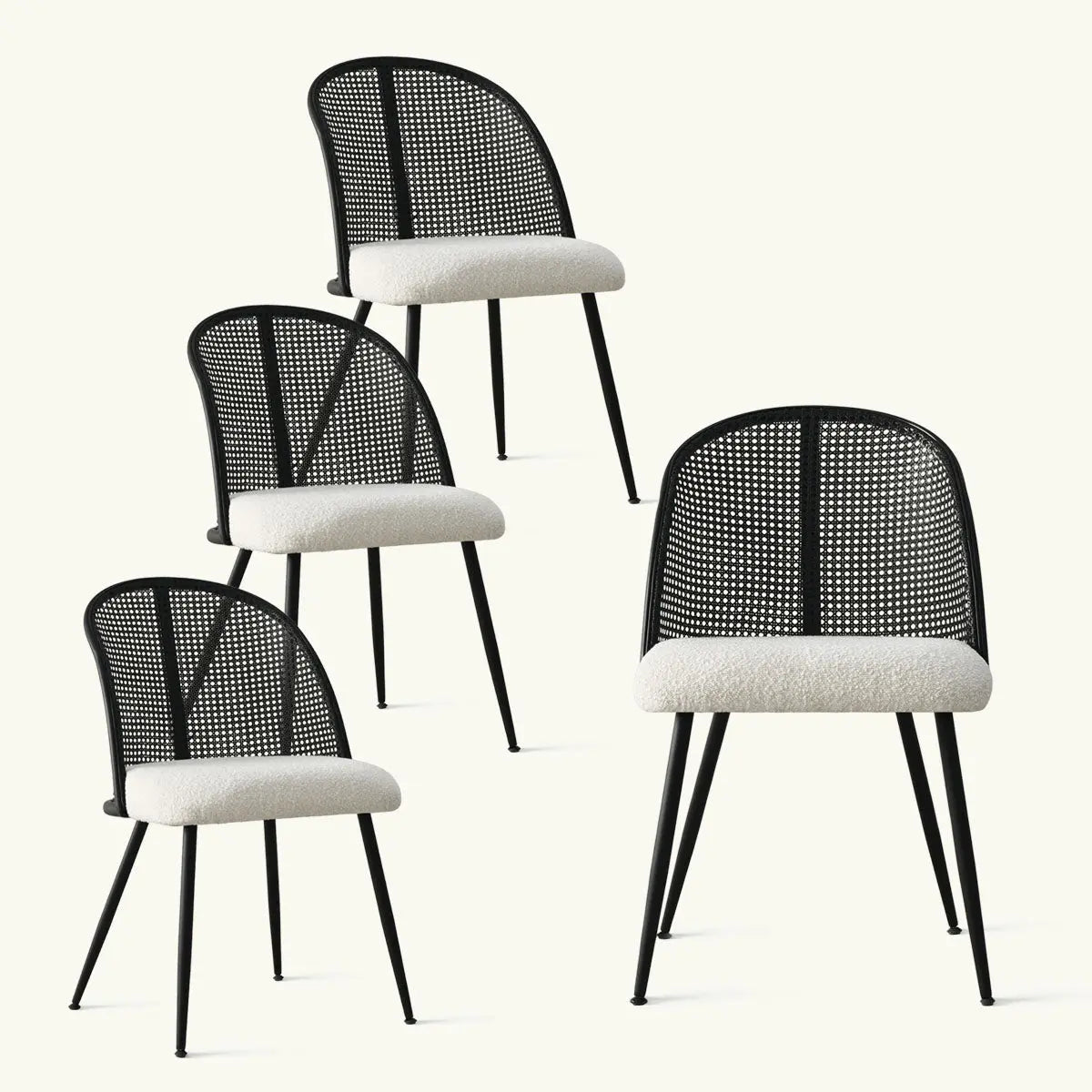 Four Lucca black rattan boucle dining chairs in a minimalist room setting against a neutral backdrop.